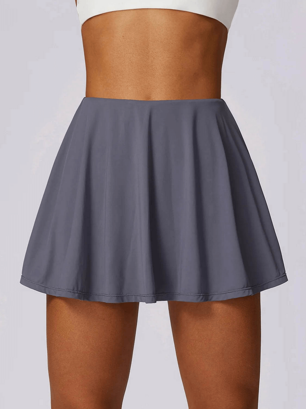 Stylish women's flared sports skirt in gray, perfect for running, hiking, and dancing, made from nylon and spandex blend.